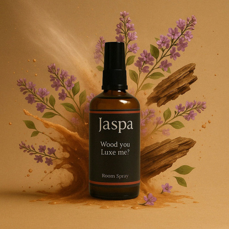Warm, softly lit bedroom scene with a Jaspa fragrance on the bedside table